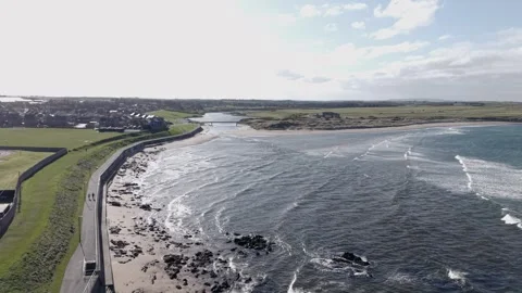 Drone View of Coastal Town with Waves and Curving Shoreline Road Video stock 333784355