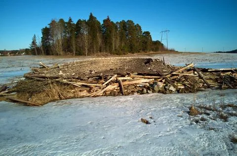 Drone view of collapsed rustic wooden barn in snowy field Stock Photos
