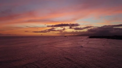 Drone view of colorful sunset sky reflecting on ocean water Oahu Stock Footage 346427901