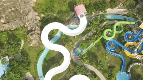Drone view colorful water slide in amusement aquapark. People having fun riding Stock Footage 106989335