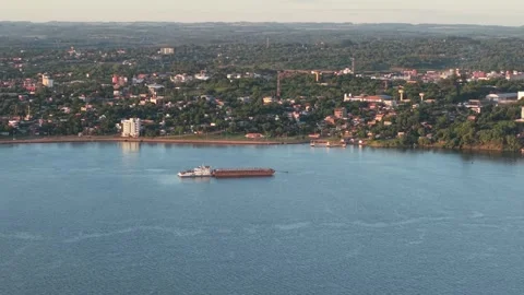 Drone view of commercial vessel navigating near coastal city, Export and import Stock Footage 311442830