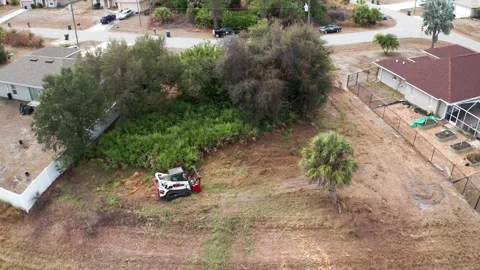 Drone View of Compact Lot Clearing with Machinery Near Residential Houses Stock-Footage 333939312