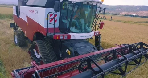 Drone view of the construction machine working in the agricultural land Stock Footage 257264878