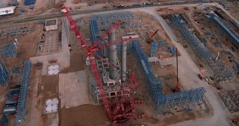 Drone view of the construction of a plant and a huge crane Stock Footage 138255249