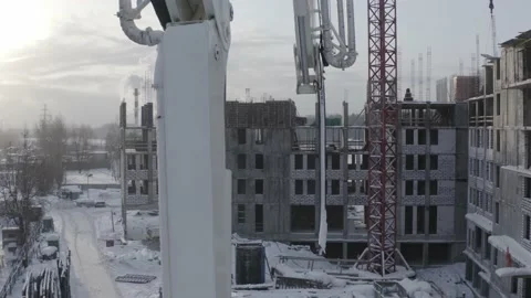 A drone view of the construction of a residential building using a concrete pump Stock Footage 200119954