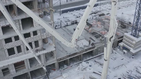 A drone view of the construction of a residential building using a concrete pump Stock Footage 200837063