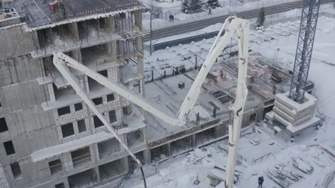 A drone view of the construction of a residential building using a concrete pump Stock Footage 201417752