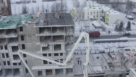A drone view of the construction of a residential building using a concrete pump Stock Footage 201954526