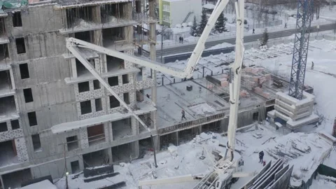 A drone view of the construction of a residential building using a concrete pump Stock Footage 203878818