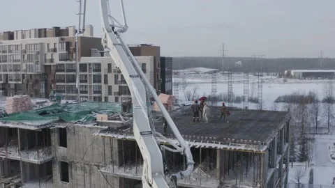 A drone view of the construction of a residential building using a concrete pump Stock Footage 204944975