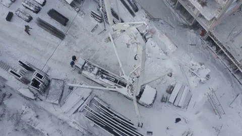 A drone view of the construction of a residential building using a concrete pump Stock Footage 209619094