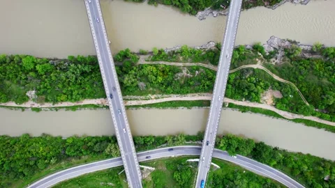 Drone view of contemporary bridge intersection above river Stock Footage 240739439