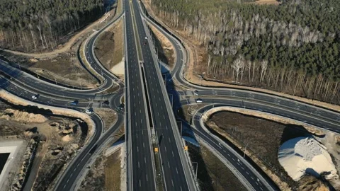 Drone view of contemporary elevated highway intersection with vehicles in Vidéo 132734143