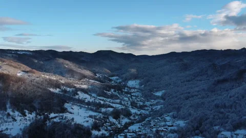 Drone view of countryside, winter forest growing in valley amidst hills Stock Footage 294033714