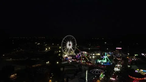 Drone view of county fair at night with multiple rides and Ferris wheel. Stock Footage 162077871
