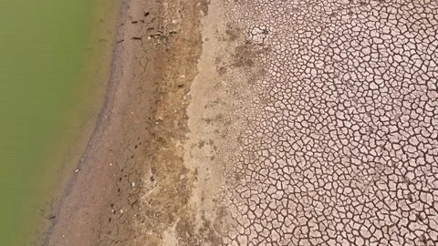 Drone view of cracked soil showing severe drought impact. Video stock 274375764