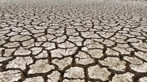 Drone view of cracked soil showing severe drought impact. Video stock 274375875
