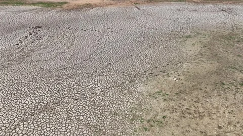 Drone view of cracked soil showing severe drought impact. Stock Footage 274375879