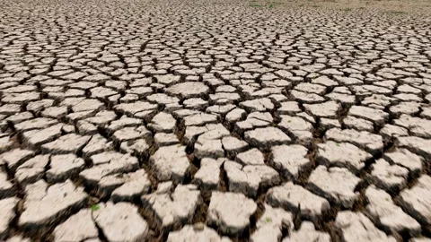 Drone view of cracked soil showing severe drought impact. Video stock 274376218