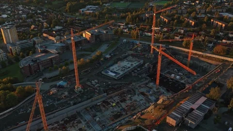 Drone view of cranes at work on Trondheim construction site at sunrise Stock Footage 320500612