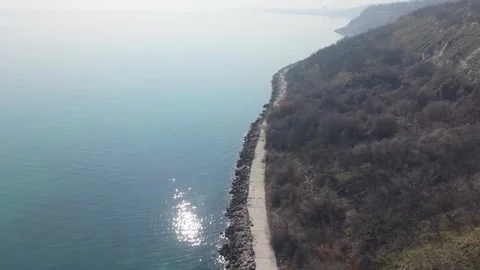 Drone View Of Curved Mountain Road Along Beautiful Sea Stock Footage 330131262