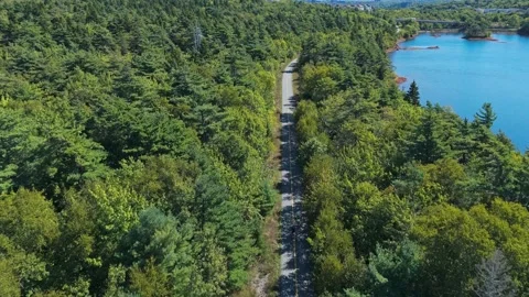 Drone View Of A Cyclist Pedaling On Trail In Halifax Park Surrounded By Greenery Stock Footage 328317476