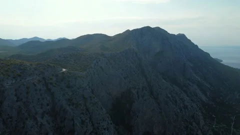 Drone view of Dalmatia coast - Mountains near Adriatic sea. Road on top Video stock 231394341