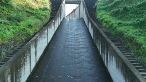 Drone View of Dam Spillway Covered with Green Vegetation Stock Footage 309915182