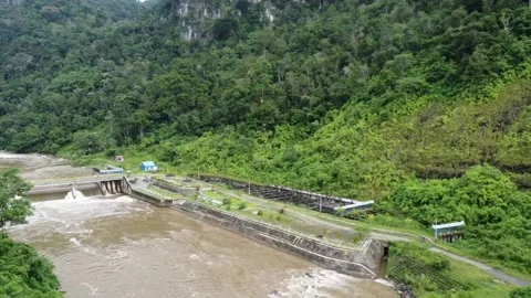 Drone View of Dam Surrounded by Dense Forest in Mountain Valley Video stock 197998658