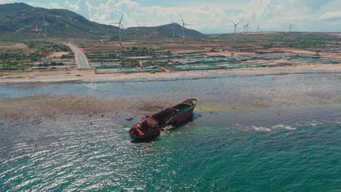 Drone view a damaged ship is stranded on the shore of Bai Thong beach, Phuoc 库存影片 336070025