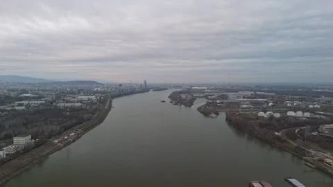 Drone view of the Danube passing Budapest's industry, homes, and transport Stock Footage 336468058