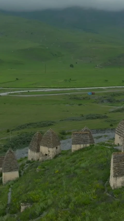 Drone view of Dargavs necropolis stone crypts in North Ossetia mountain valley Stock Footage 346557617