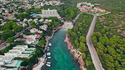 Drone view of deep turquoise-blue cove, with calm sea around luxury resorts. Stock Footage 219571372