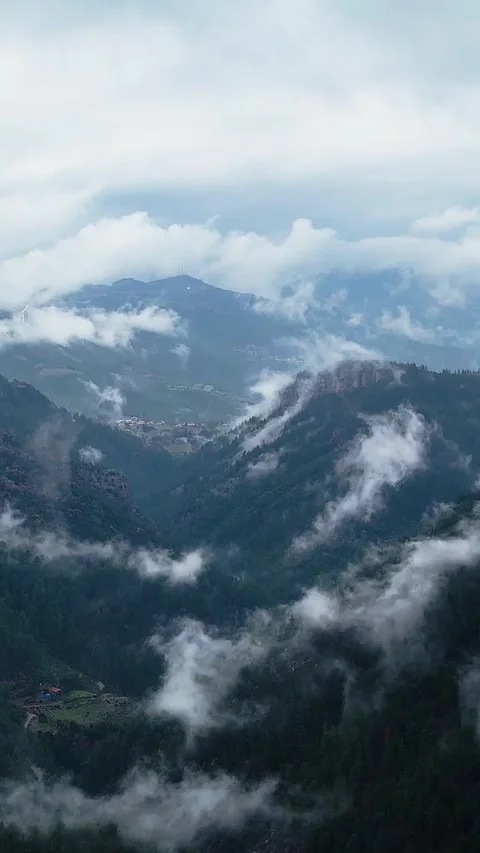 Drone View of Dense Fog Drifting Across Mountain Slopes Vertical 1080p Stock Footage 331265442