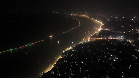 Drone View of Dev Diwali at Banaras: Ganga River and Glowing Ghats at Night Stock Footage 295049377