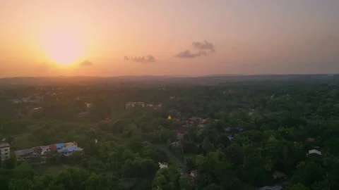 Drone view of Devrukh village, Konkan with lush greenery, mountains &amp; sunset Video stock 304491417