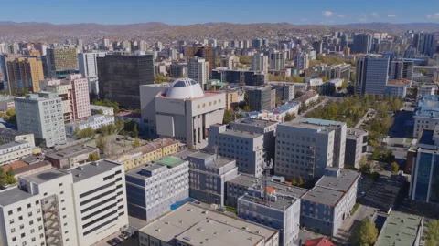 Drone view of downtown Ulaanbaatar featuring a white domed building amid office Stock Footage 347877591