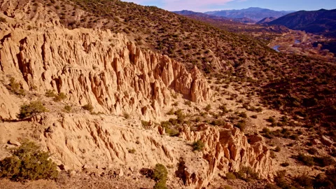 Drone view of dramatic red rock formations under desert skies 스톡 동영상 334766496