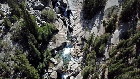 Drone view dropping down to rocky canyon waterfalls Stock Footage 96356300