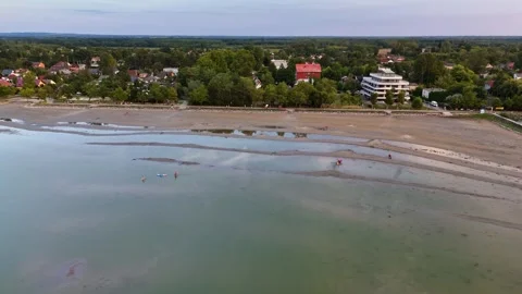 Drone view of drought-hit Lake Balaton marina and sandbars at summer dusk Stock Footage 345064508
