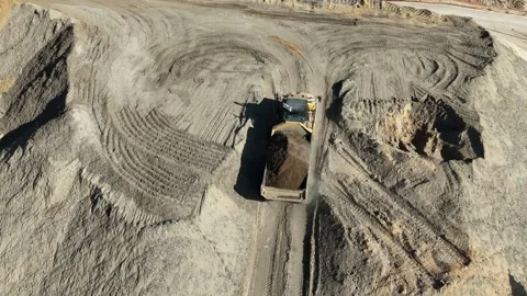 Drone view of dump trucks and tractors working at a construction site Stock Footage 294722740