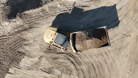 Drone view of dump trucks and tractors working at a construction site Stock Footage 294722750