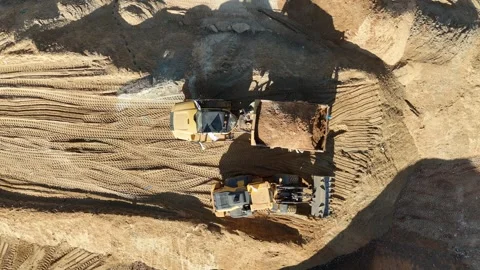 Drone view of dump trucks and tractors working at a construction site Stock Footage 294722944