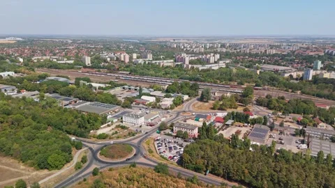 Drone view of Dunaújváros panel buildings, roads and train station below Vídeos de archivo 346152407