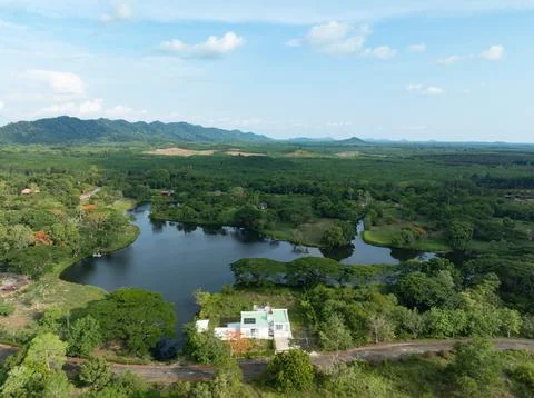 Drone view of eco friendly lakeside resort with a solar powered house, lush.. Stock Photos