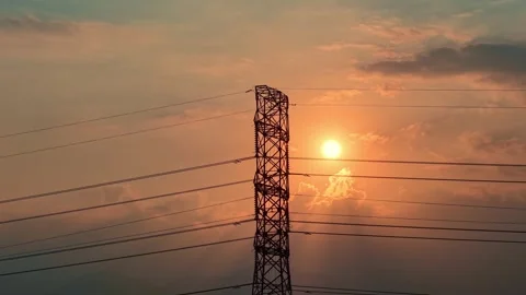Drone view of electrical pylon silhouette with sun setting behind, Stock Footage 345293508
