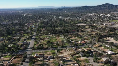 Drone view of empty lots of homes left behind from the Eaton fire Video stock 328063461