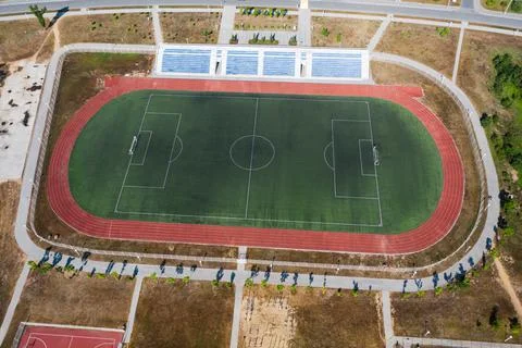 Drone view of an empty soccer field with stands and treadmills Stock Photos