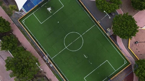 Drone view of an empty synthetic grass soccer field in the center of a park Stock Footage 280276728