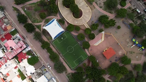 Drone view of an empty synthetic grass soccer field in the center of a park Stock Footage 280276752